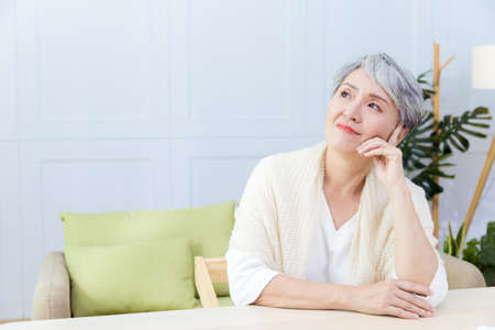 Asian senior woman suffer from cough with face mask protectionの写真素材