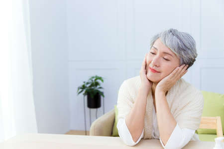 Asian senior woman suffer from cough with face mask protection