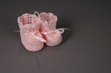 It's a girl! Knitted booties with neutral backgroundの写真素材
