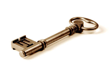 Vintage key in a cose up view isolated over a white background