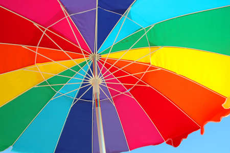 Multicolor umbrella against a blue sky