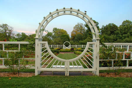Garden with ornamental arch i late afternoon.の写真素材