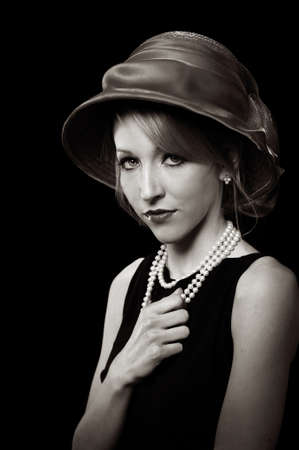 BEautiful young woman wearing a red hat isolated over a black background