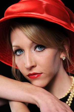 Close up portrait of beautiful young woman with red hat