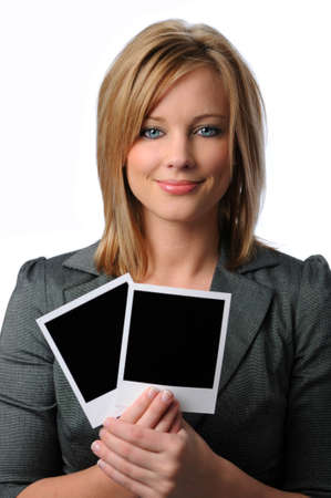 Beautiful young woman holding two blank Polaroid photosの写真素材