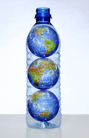 Earth with continents inside empty water bottleの写真素材