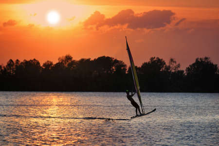 Windsurfer during a sunsetの写真素材