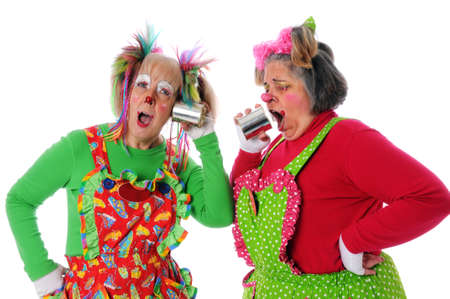 Two clowns using a tin can phone to communicate