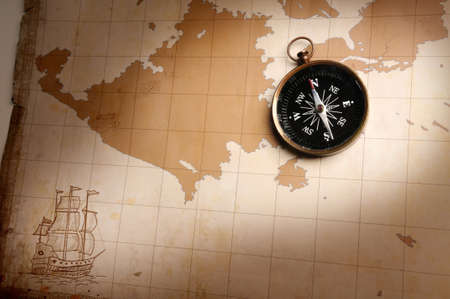 Compass over an old map with directional lightの写真素材