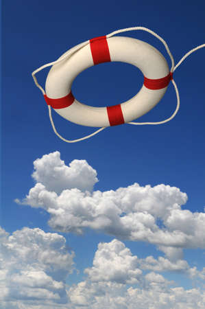 Life preserver over a blue sky with bright cloudsの写真素材