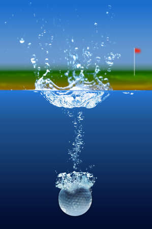 Golf ball splashing into water with green in backgroundの写真素材