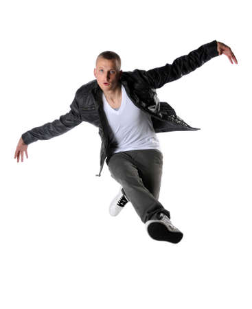 Young hip hop dancer performing a jump isolated over a white backgroundの写真素材