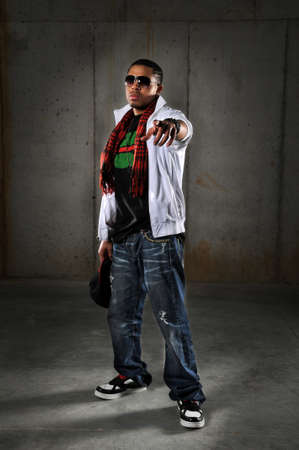 Hip hop African American man pointing over an urban backgroundの写真素材
