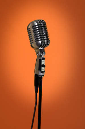 Vintage microphone over orange backgroundの写真素材