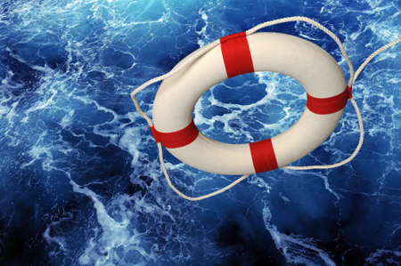 Lifering falling on blue churning waterの写真素材