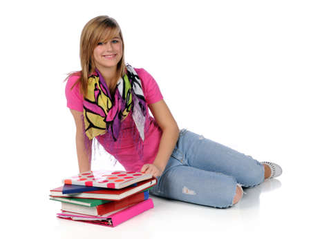 Young woman with books sitting on white floorの写真素材