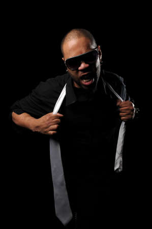 African American man pulling necktie isolated over black