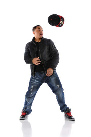 African American hip hop dancer throwing hat isolated over white