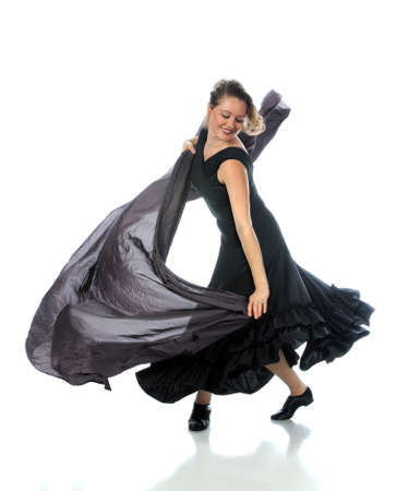 Modern ballet dancer dressed in black performing over white backgroundの写真素材