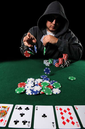 Poker played with hood and sunglasses throwing chips on stackのeditorial素材