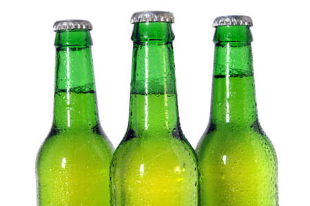 Three green beer bottles isolated on white background -  Selective focus on front bottleの写真素材