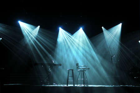 Stage with bright lights and microphones ready for concertの写真素材