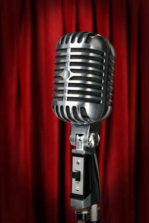 Vintage microphone with red curtain in backgroundの写真素材