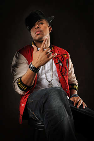 African American hip hop man posing over dark background