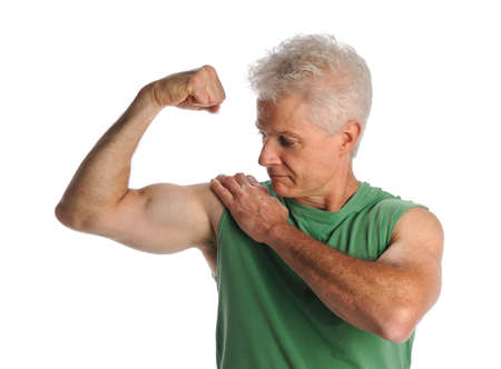 Portrait of mature man flexing biceps isolated over white backgroundの写真素材