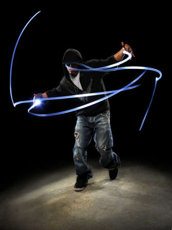 African American hip hop dancer with LED lights painting patternsの写真素材