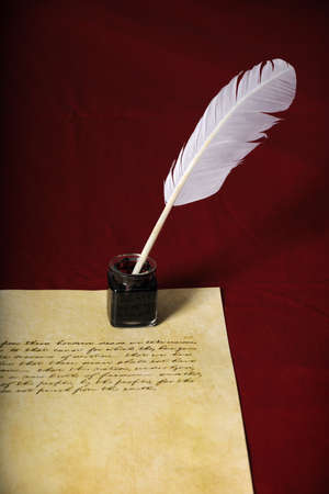 Quill, pen and handwritten text on parchment paperの写真素材
