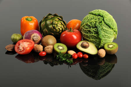 Fresh fruits and vegetables with reflections on table