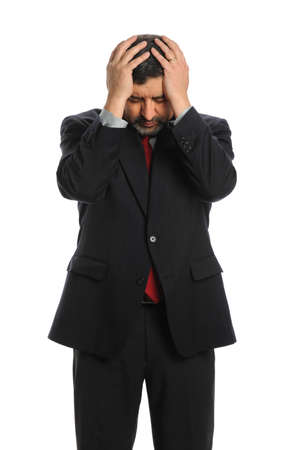 Portrait of Hispanic businessman stressed with hands on head isolated over white backgroundの写真素材