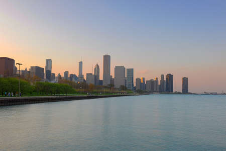 Downtown Chicago at dusk with Michigan lake in foreground