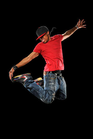 African American hip hop dancer jumping isolated over black background