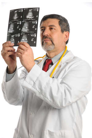 Hispanic doctor examining ultrasound film isolated over white backgroundの写真素材
