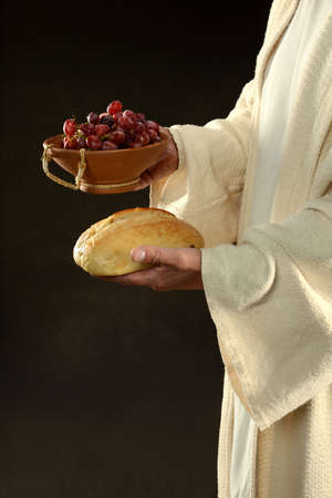 Jesus holding bread and grapes symbols of communionの写真素材