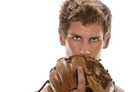 Young man holding baseball glove in front of face isolated over white backgroundの写真素材