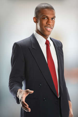 African American businessman offering handshake isolated indoorsの写真素材