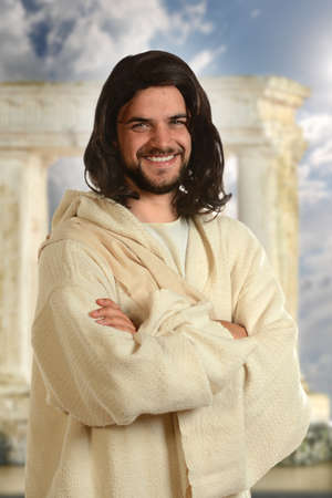 Portrait of Jesus smiling with arms crossed with temple in backgroundの写真素材