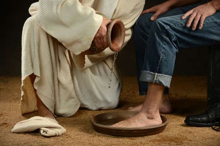 Jesus washing feet of modern man wearing jeans