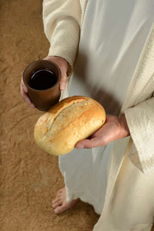 Jesus hands holding bread and cup of wime
