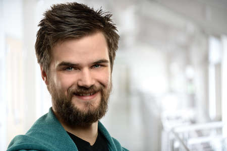 Portrait of young man smiling inside building