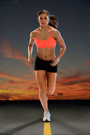 Young African American woman running at sunset