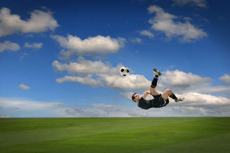 Soccer player kicking ball outdoors during sunny day
