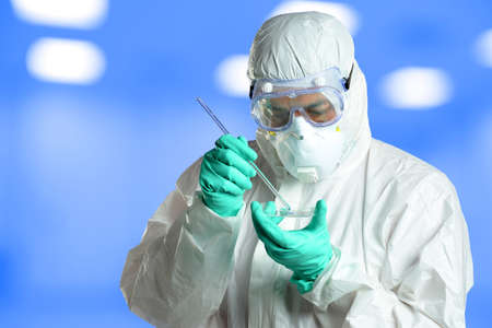 Scientist in protective clothing working in laboratoryの写真素材