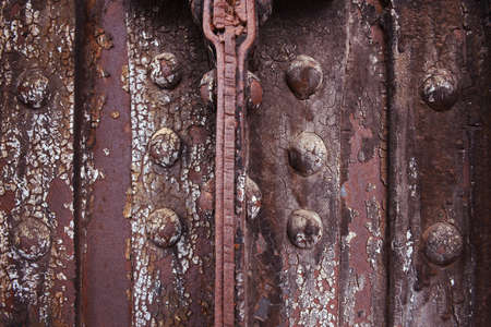 Rusted metal background with bolts and rivets