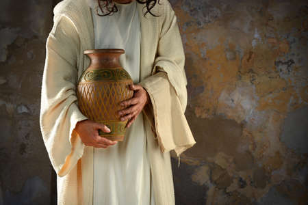 Jesus hands holding water jar ready to wash the disciples' feetの写真素材