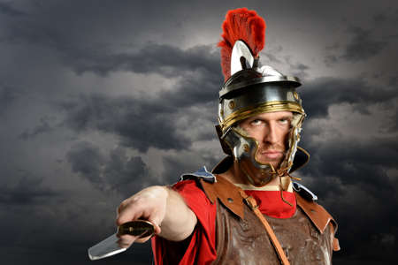 Portrait of Roman soldier brandishing sword over dark clouds