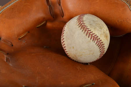 Old baseball on carther's leather gloveの写真素材